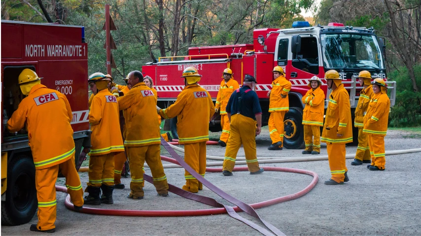 MELBOURNE, AUSTRALIA - February 10, 2015: Volunteer fire fighters from the North Warrandyte brigade of the Country Fire Authority practicing by the Yarra River in Warrandyte, with Isuzu fire trucks.